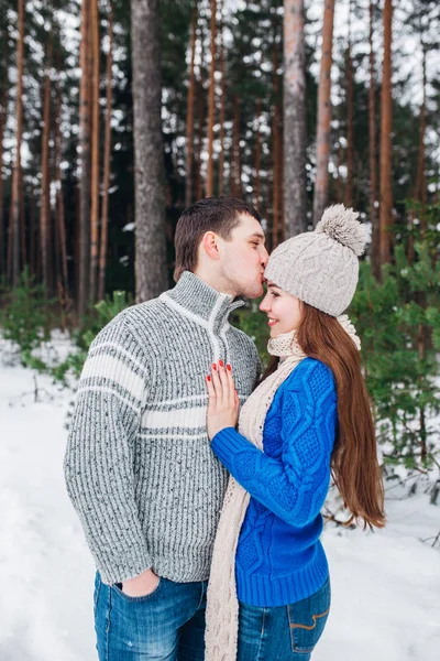 Feliz casal abraçando e rindo ao ar livre na floresta de inverno — Fotografia de Stock