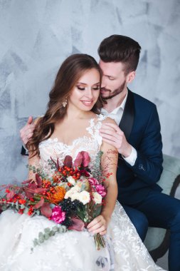 Evlilik çift kapalı birbirlerine sarılıyor. Studio beyaz elbiseli güzel model kız. Takım elbiseli adam. Güzellik gelinle damat