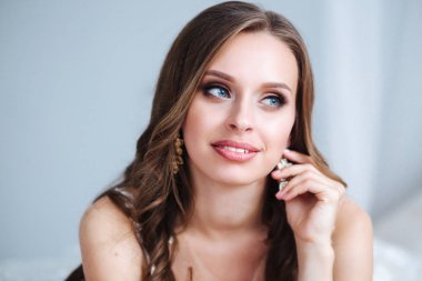 Muhteşem genç gelin portre kapalı. Güzel gelin düğün makyaj ve takı uzun kıvırcık saç ile. Gelin moda model iç poz.