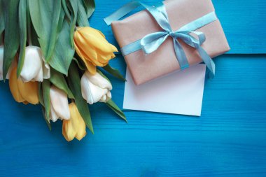 Kahve kupa laleler ve hediye yukarıda, güzel Kahvaltı, vintage kartı, üstten görünüm turkuaz rustik masada buket düz yatıyordu