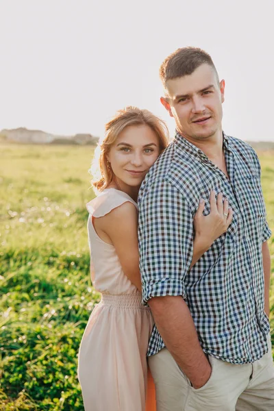 Young couple in love in summer in field.Couple hugging outdoor. — Stock Photo, Image
