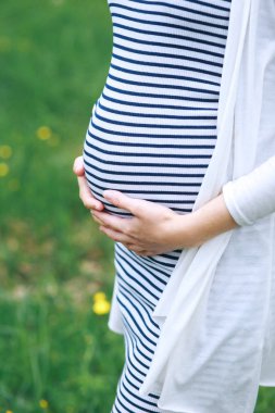 Koca göbeğine dokunmak ve parkta yürüyüş hamile kadın