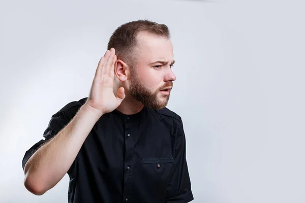 Businessman hold his hand near ear for listening carefully — Stock Photo, Image