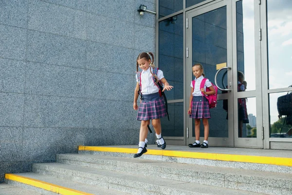 Група дівчаток початкової школи закінчує шкільні будівлі до камери в кінці класу — стокове фото