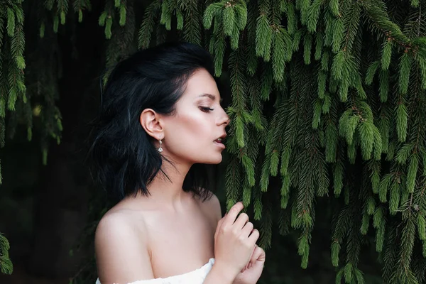 Enjoying the nature. Young woman enjoying the fresh air in green forest.