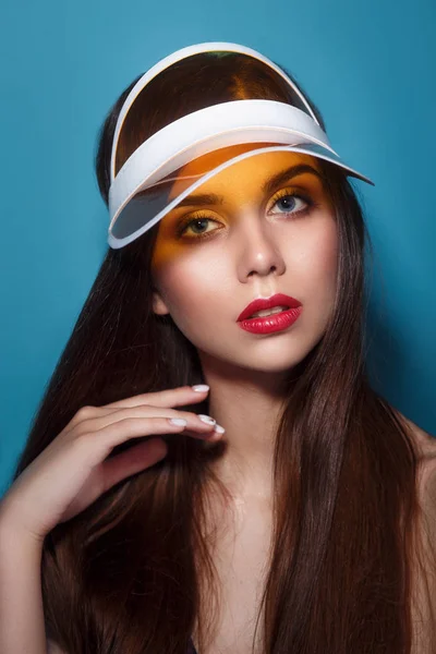 Close-up retrato de verão de uma bela jovem mulher com lábios vermelhos usando viseira sol amarelo . — Fotografia de Stock