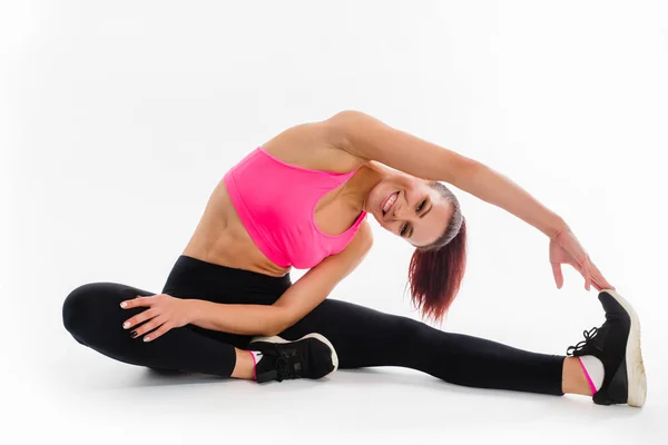 Fitness kvinna göra stretching motion på vit bakgrund — Stockfoto