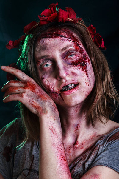 Close-up portrait of horrible zombie woman with wounds. Horror. Halloween poster. The shouting female zombie