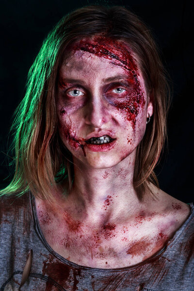 Close-up portrait of horrible zombie woman with wounds. Horror. Halloween poster. The shouting female zombie