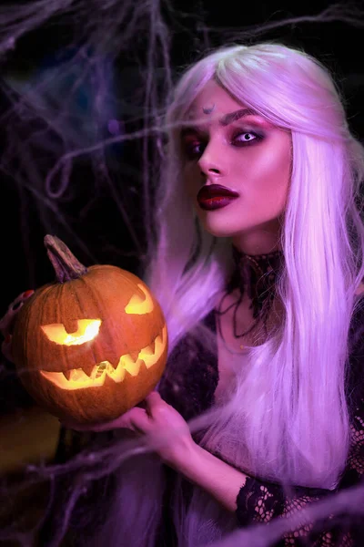 Mysterious Halloween witch woman portrait with pumpkin. — Stock Photo, Image