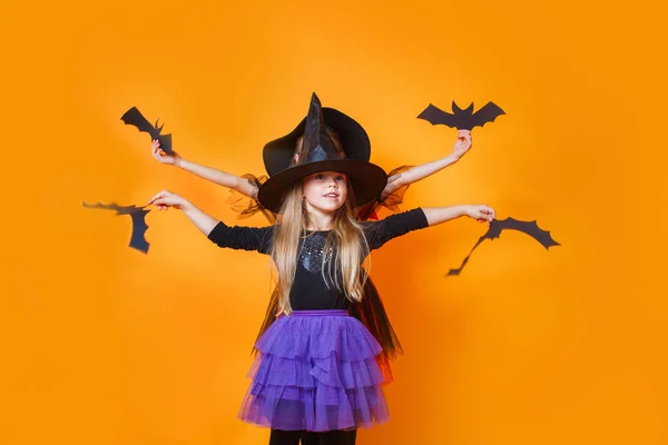 Two little girls in halloween costumes having fun on orange background — Stock Photo, Image