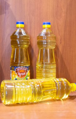 Sunflower oil in bottles from a set of products that were given out at school to students from large families in may 2020, during self-isolation due to the spread of coronavirus infection.  clipart