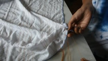 Taylandlı kadın emekçilerin Batik kravat doğal boyama renk süreci: Nonthaburi, Thailand atölyesinde kumaş üzerine bundle ve dikiş veya arashi shibori kat