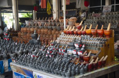 Thai people and travelers buy from mortar and souvenir from souvenir gift local shop at Ang Sila jetty fish local market on January 2, 2017 in Chonburi, Thailand clipart