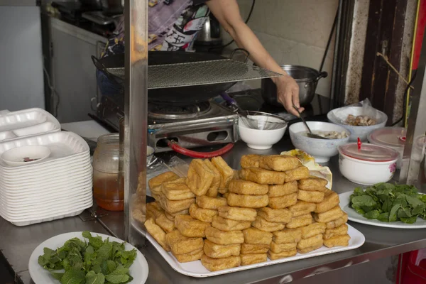 Chinese people cooking Fried Tofu with vegetables and sweet sauc