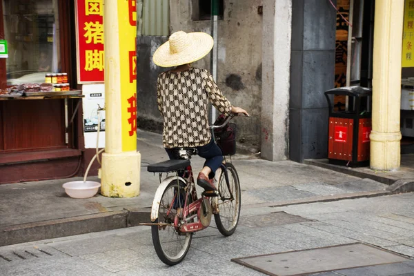 Chinese people old women ride and bike bicycle on Paifang Street — Stock Photo, Image