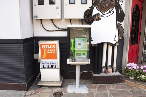 Old public telephone in booth for people use at outdoor of build — Stock Photo, Image