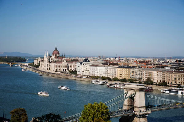 View landscape and cityscape of Budapest old town city and Hungarian Parliament with tour cruises in Danube Delta river and Budapest Chain Bridge in Budapest, Hungary