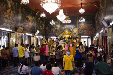 Taylandlılar ve yabancı gezginler, 12 Temmuz 2020 'de Tayland Samut Prakan' da Bang Phli Yai 'deki Wat Bang Phli Yai Tapınağı' nda dua ve ayin tanrısı Buda heykeline saygı duyarlar.