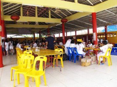 Thai people religious or pilgrims join soup kitchen tradition merit ritual donate food offering almsgiving in almshouse chinese shrine at Vegetarian Festival on October 20, 2012 in Phuket, Thailand