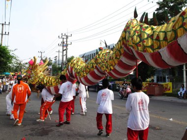 Thai people performed Dragon Dance parade traditional chinese culture respect deity angel god goddess in thetsakan kin che or Vegetarian Festival at lunar month on October 20, 2012 in Phuket, Thailand