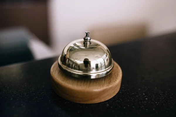 Restaurant service bell on the table vintage with bokeh, evening