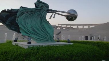 Doha Katar 'daki Katara Kültür Köyü öğleden sonra çekimleri ön planda Doğanın Gücü 2 heykelini, çeşmeyi ve arka planda Amfitiyatroyu gösteriyor.