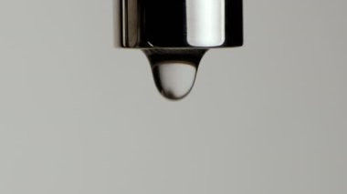 Musluktan damlayan su damlalarının yavaş hareketi.