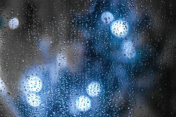 Raindrops on Window, blue lights in background
