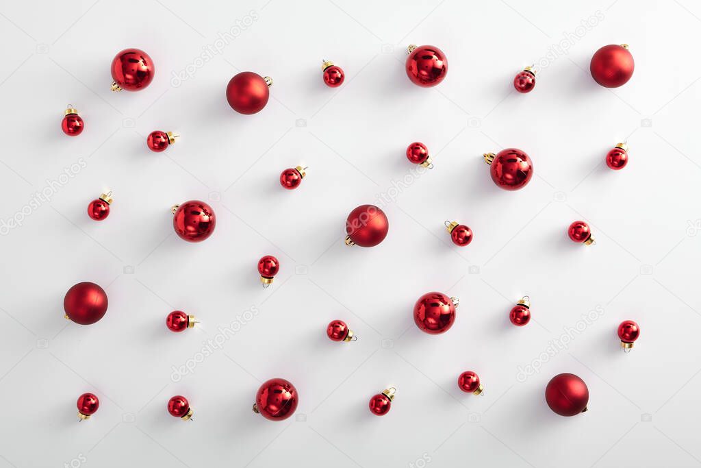Christmas minimal pattern - red xmas ball on white background. Horizontal composition with white frame. Flat lay, top view.