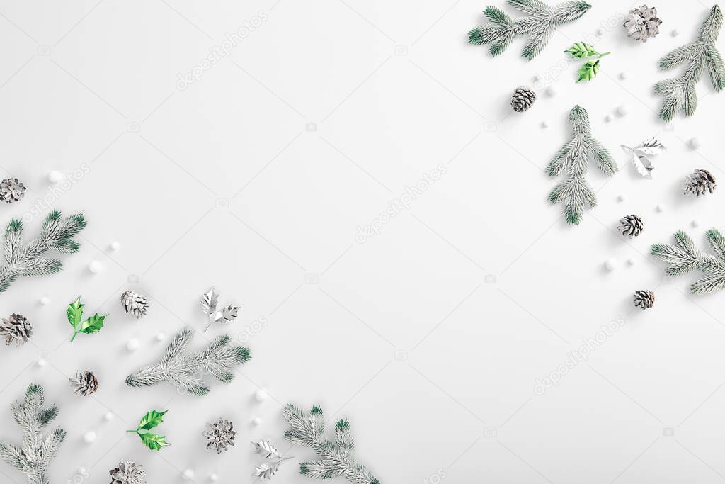 Winter minimal concept - Evergreen tree branch with snow and pine cones. Horizontal composition, flat lay, top view. Snow forest creative minimal layout. Abstract snowflake background.