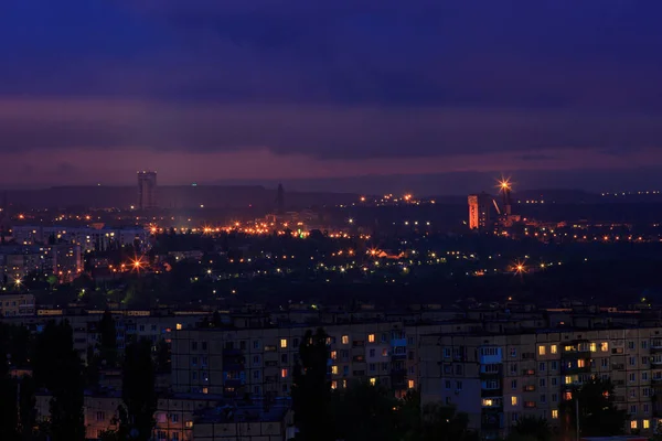 A night city in eastern Europe. On the outskirts of the city, an ore mine