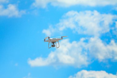 Bulutlu gökyüzünün arkaplanındaki dörtgen helikopter