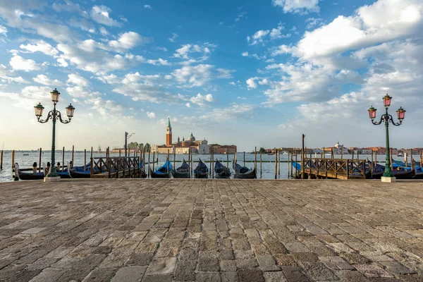 Gondolas moored by Saint Mark square with San Giorgio di Maggiore church in Venice, Italy Stock Image