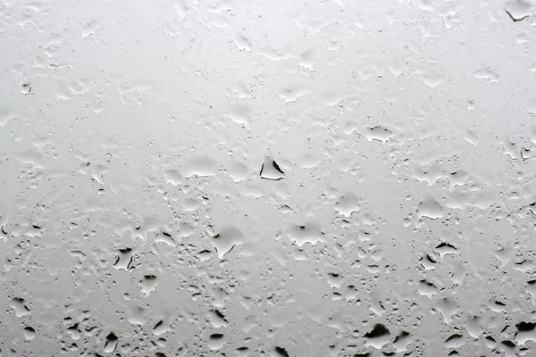 Few raindrops on the window pane close up outside the window gray sky — Stock Photo, Image