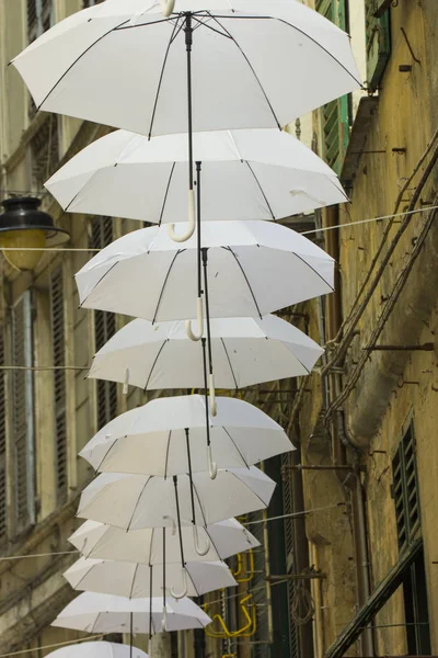 Ornamental white umbrellas in the city in Genoa