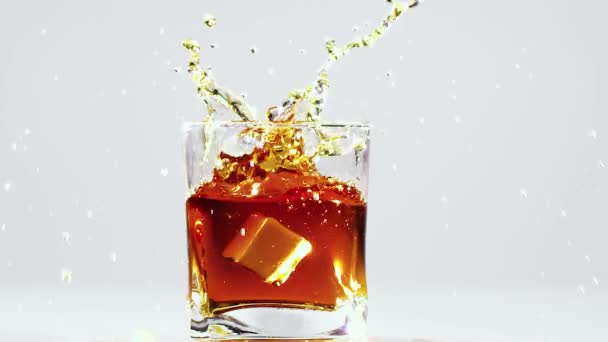 Two Ice Cubes Falling Glass Brandy — Stock Video