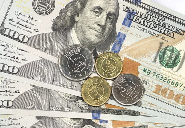 Kuwaiti Dinar coin on top of dollar bills — Stock Photo, Image
