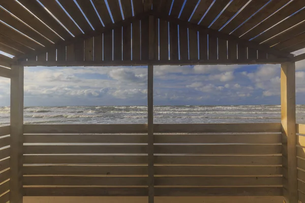 View from the beach gazebo to the stormy sea — Stock Photo, Image