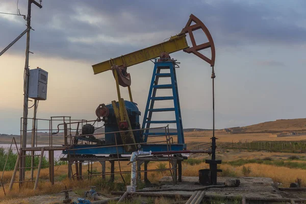 Oil rocking at sunset — Stock Photo, Image