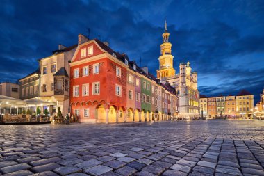 Stary Rynek square with small colorful houses and old Town Hall at dusk in Poznan, Poland clipart