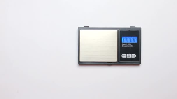 Electronic scales next to put a medical cannabis plant before selling — Stock Video