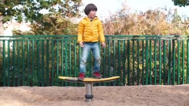 The boy is dancing in yellow clothes at the site.