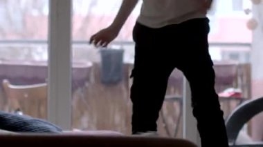 A joyful parent interacts with their child, dancing and playing in a bright living room, capturing the essence of family fun and togetherness.