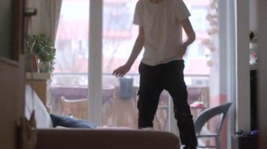 A joyful scene of a child and caregiver dancing and playing together indoors, creating cherished memories in a cozy home environment.