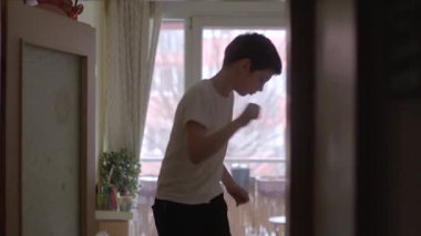 Two playful children enjoy their time indoors, showcasing sibling joy and interaction. A warm, cozy environment captures the essence of childhood fun.