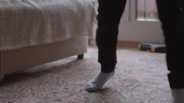A child engages in playful activities on a cozy carpet, showcasing dynamic movements and energetic expressions in a bright room.