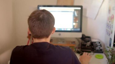 An individual is actively engaged in computer work, illustrating a highly focused and organized workspace environment