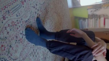 A young child is curled up in a cozy chair, lost in thoughtful contemplation, capturing a serene moment of introspection