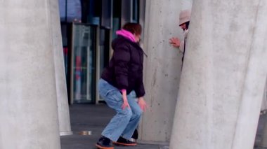 A man and woman share a joyful moment on a sidewalk, followed by a woman skateboarding. The scene shifts to another woman kneeling in thought